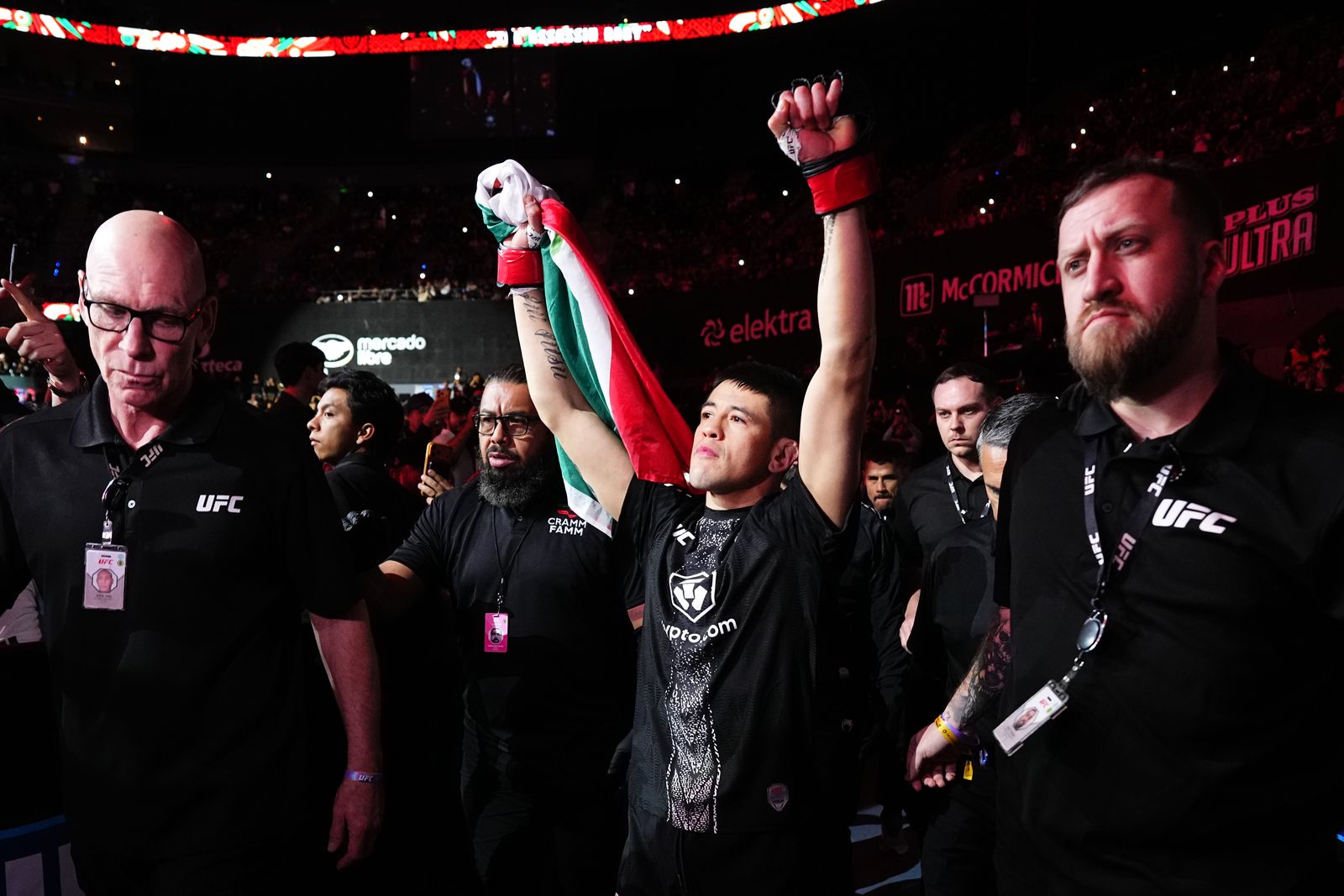 UFC fighter walking out to the octagon with arms raised