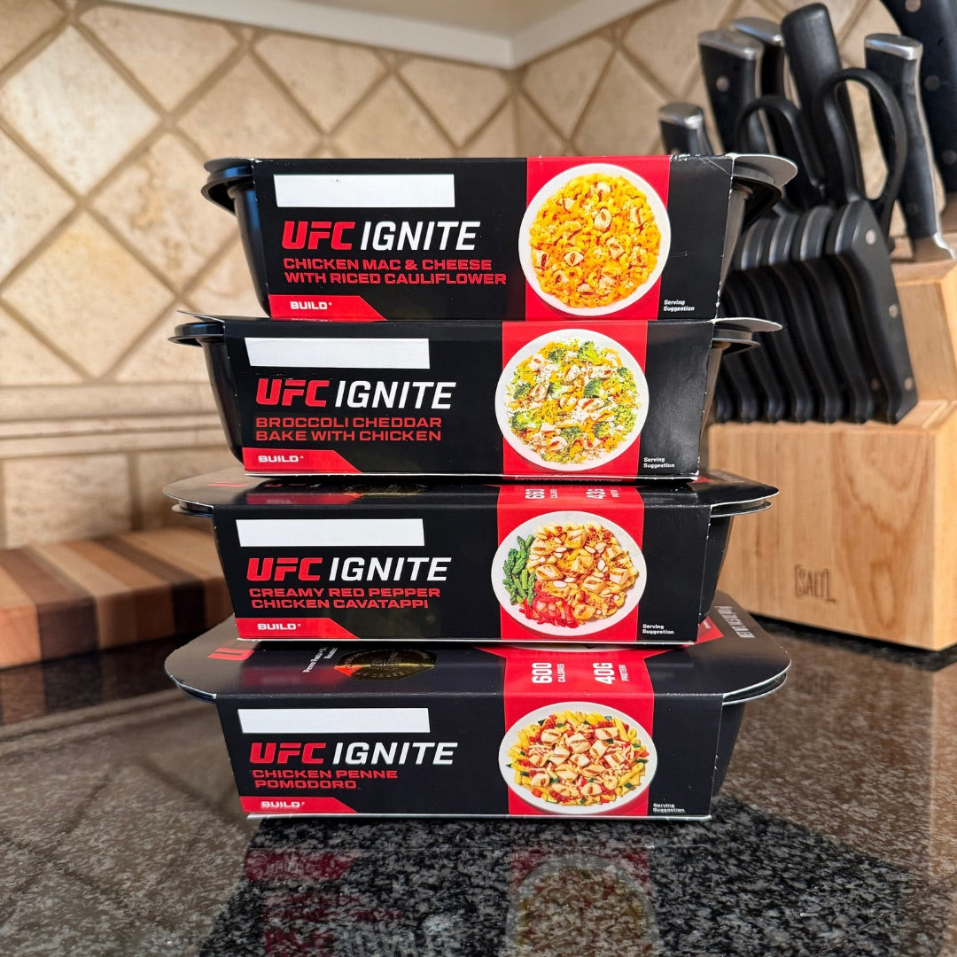 Four UFC Ignite Liberty Box meals stacked in a kitchen